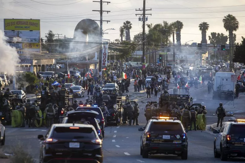 Law enforcement clashing with demonstrators during a protest in the Compton neighborhood of Los Angeles on June 7. RINGO CHIU/AFP via Getty Images