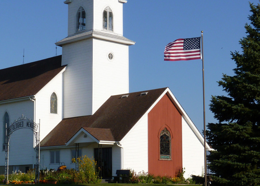 american flag in front of a church