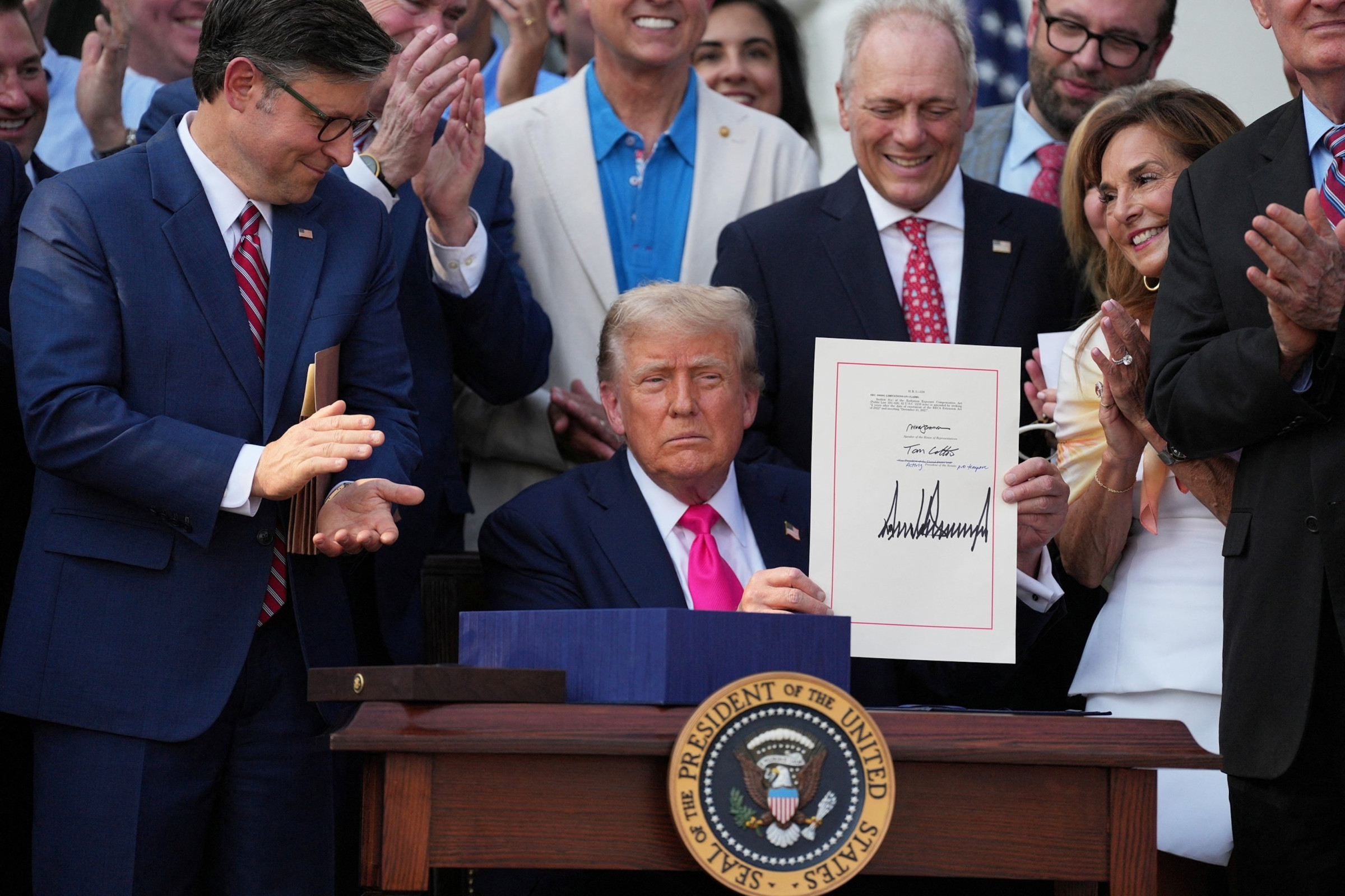 President Donald Trump signing a bill at the White House