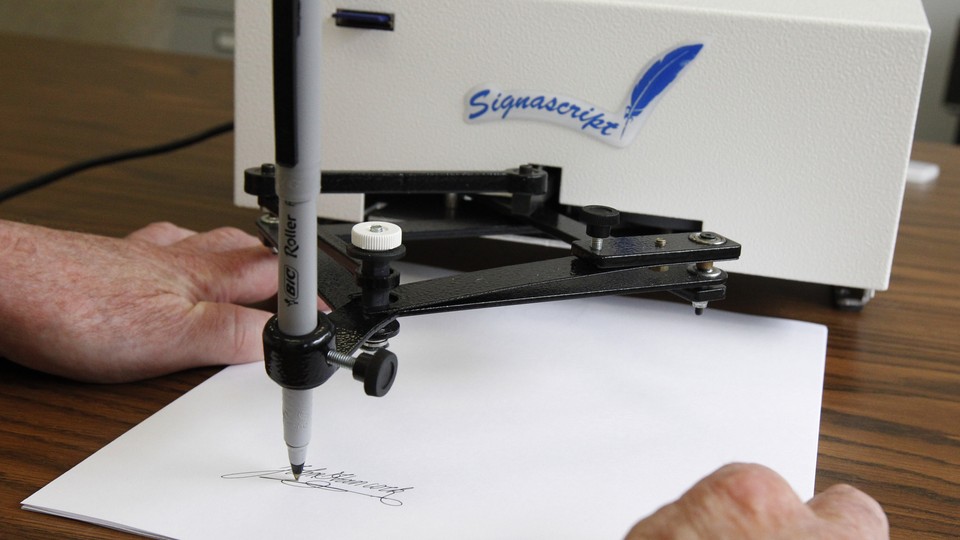 Autopen machine signing a document